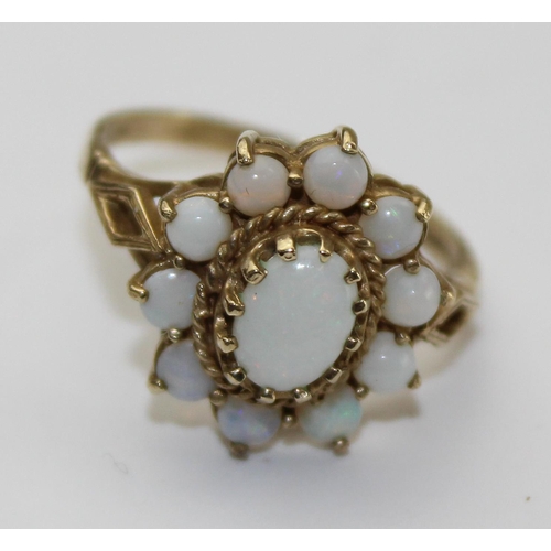 1243 - 9ct gold and opal ring in floral setting, full English hallmarks, approx size P, approx 3.01g gross ... 