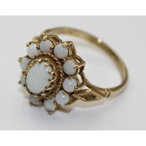 1243 - 9ct gold and opal ring in floral setting, full English hallmarks, approx size P, approx 3.01g gross ... 