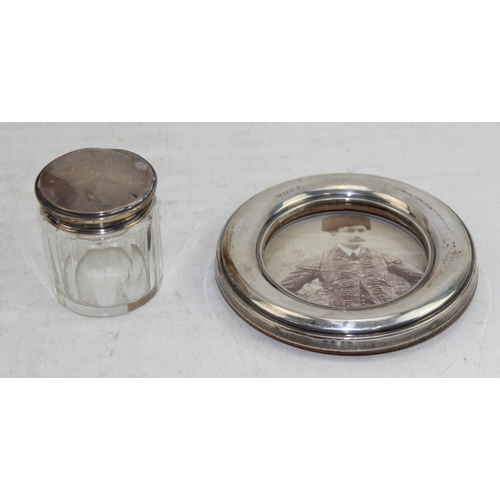 1158 - Silver topped glass jar and a silver mounted photograph frame