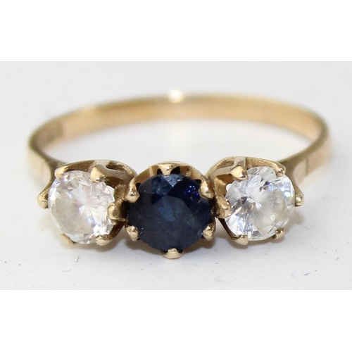 1248 - 9ct gold ring with a central blue stone flanked by a pair of white stones, full English hallmarks, a... 