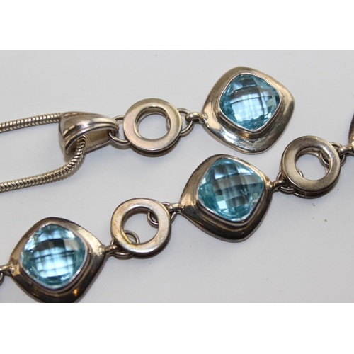 1255 - A 925 silver bracelet with facet cut blue stones and a matching silver pendant on matched silver cha... 