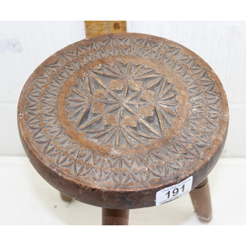 191 - A vintage wooden milking stool with carved wooden top