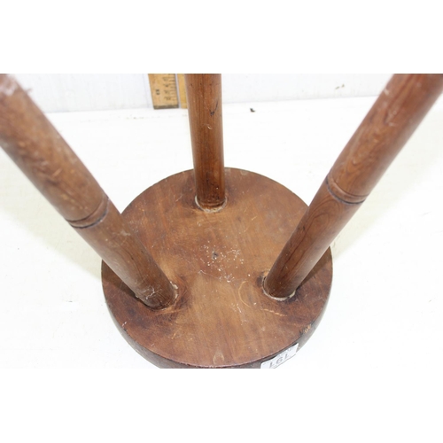 191 - A vintage wooden milking stool with carved wooden top