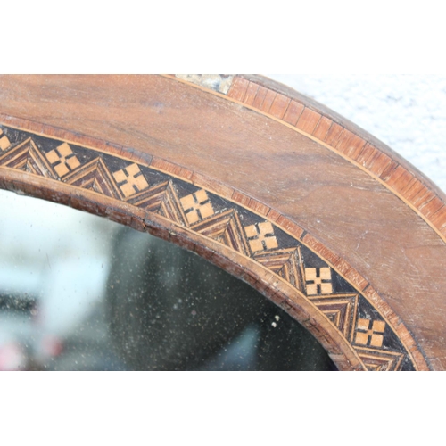 528 - A large wooden framed overmantel mirror with inlaid decoration