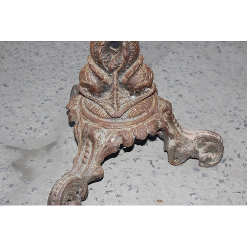 359 - An antique cast iron table base decorated with mythical creatures, likely late 19th century