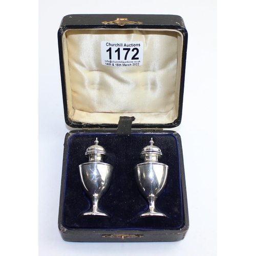 1172 - A pair of boxed silver pepperettes, Birmingham 1910 by Broadway & Co, approx 43.4g gross