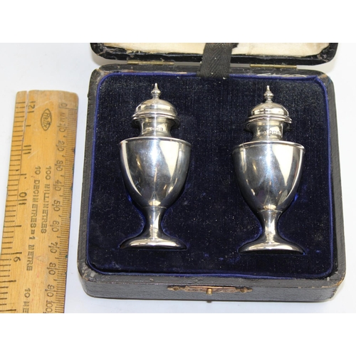 1172 - A pair of boxed silver pepperettes, Birmingham 1910 by Broadway & Co, approx 43.4g gross