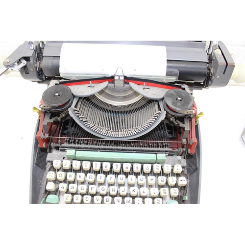 717 - Vintage Olympia International typewriter with cover  - this lot is being sold for Charity on behalf ... 