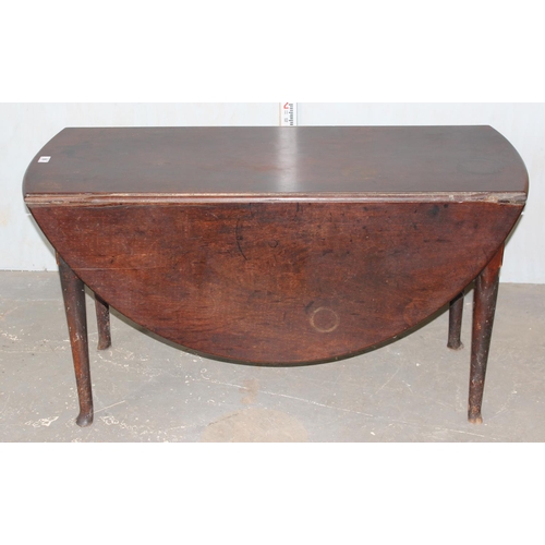 199 - A large antique Mahogany drop leaf table standing on pad feet