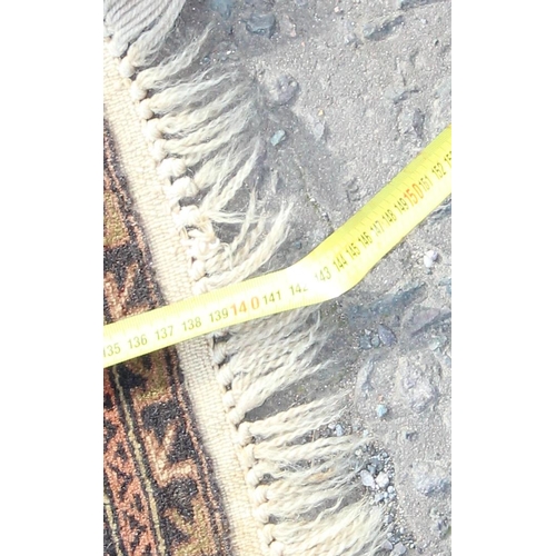 200 - A vintage handmade prayer rug with geometric design, approx 140cm x 90cm, import label verso