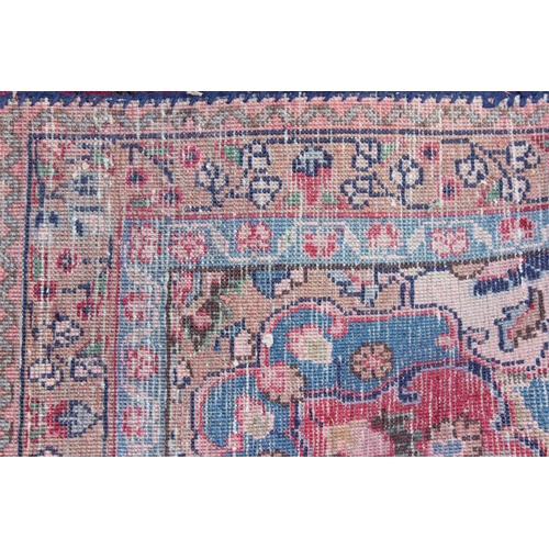202 - A large Persian handmade rug of red ground with large central medallion, labelled verso, approx 309c... 