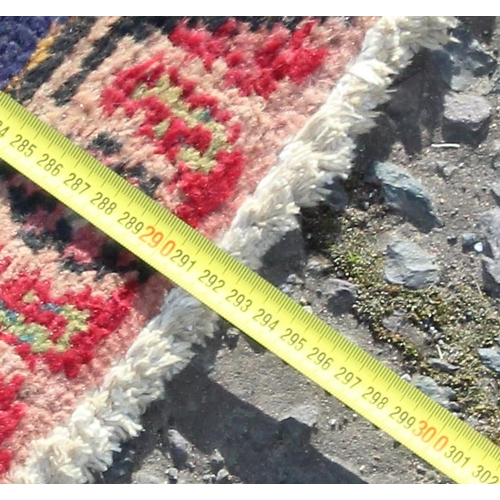 203 - A large vintage Persian handmade rug of red & blue ground with palmette border, approx 292cm x 200cm... 