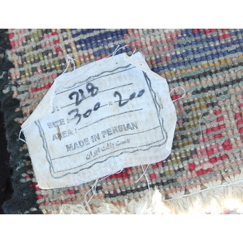 203 - A large vintage Persian handmade rug of red & blue ground with palmette border, approx 292cm x 200cm... 