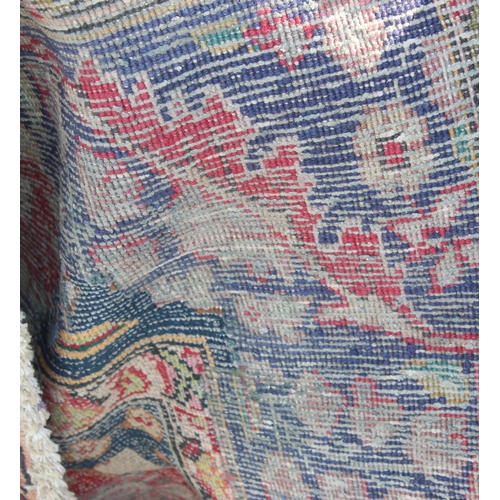 203 - A large vintage Persian handmade rug of red & blue ground with palmette border, approx 292cm x 200cm... 
