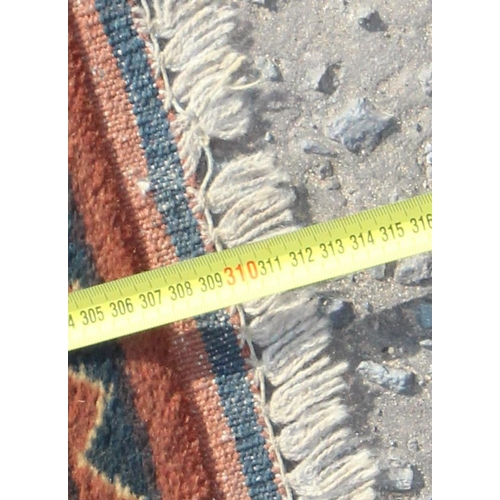 204 - A large vintage hand made rug with 3 lines of 5 gul and geometric border, approx 310cm x 240cm