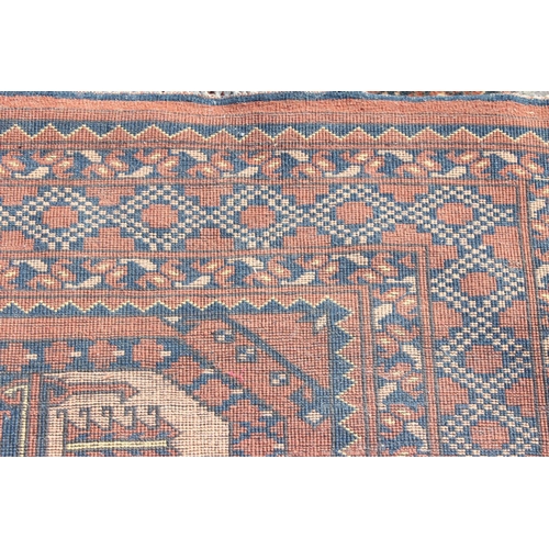 204 - A large vintage hand made rug with 3 lines of 5 gul and geometric border, approx 310cm x 240cm