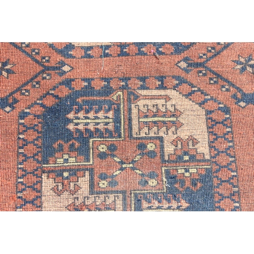 204 - A large vintage hand made rug with 3 lines of 5 gul and geometric border, approx 310cm x 240cm