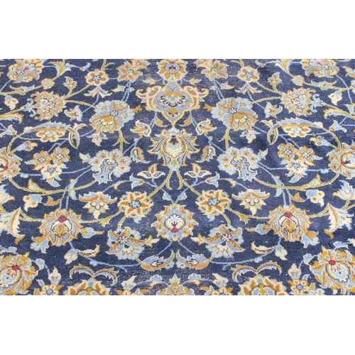 205 - A large Iranian hand knotted rug of blue ground with various decorative arabesque motifs, approx 410... 