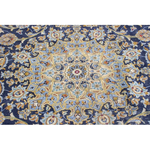 205 - A large Iranian hand knotted rug of blue ground with various decorative arabesque motifs, approx 410... 