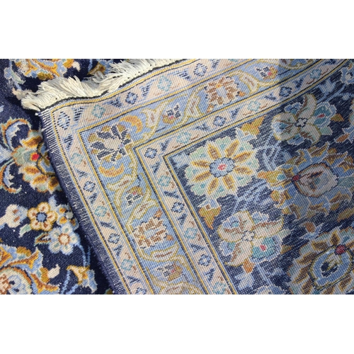 205 - A large Iranian hand knotted rug of blue ground with various decorative arabesque motifs, approx 410... 