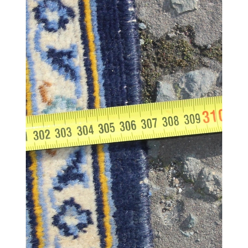 205 - A large Iranian hand knotted rug of blue ground with various decorative arabesque motifs, approx 410... 