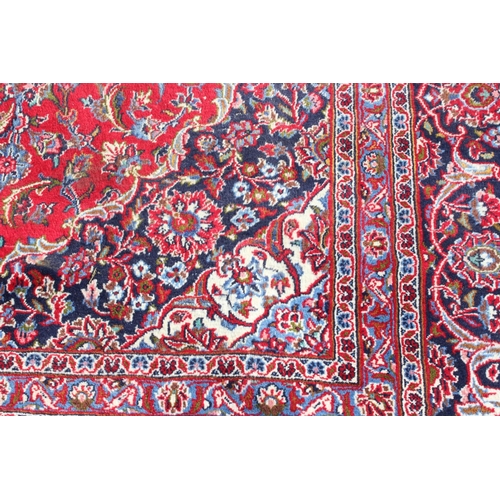 206 - A large good quality and highly decorative rug, likely Iranian of red & blue ground, approx 377cm x ... 
