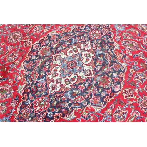 206 - A large good quality and highly decorative rug, likely Iranian of red & blue ground, approx 377cm x ... 