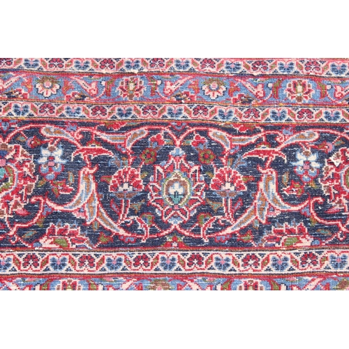 206 - A large good quality and highly decorative rug, likely Iranian of red & blue ground, approx 377cm x ... 