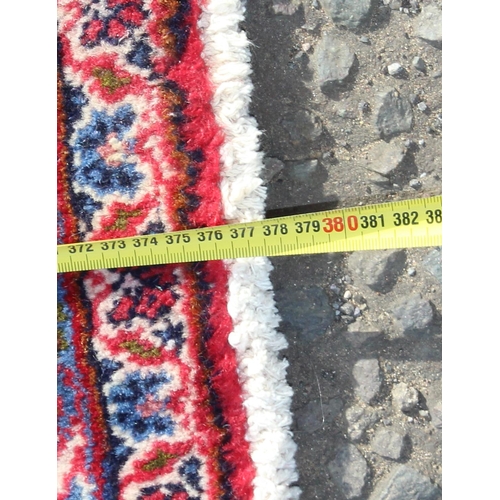 206 - A large good quality and highly decorative rug, likely Iranian of red & blue ground, approx 377cm x ... 