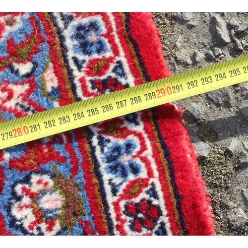206 - A large good quality and highly decorative rug, likely Iranian of red & blue ground, approx 377cm x ... 