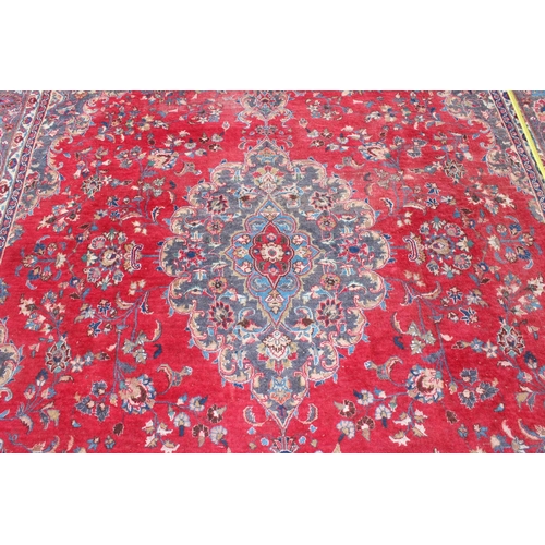 208 - A large decorative Persian rug of red ground with Herati border, approx 362cm x 271cm, label verso