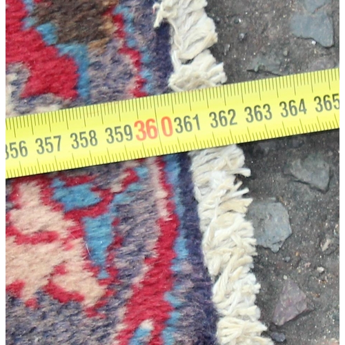 208 - A large decorative Persian rug of red ground with Herati border, approx 362cm x 271cm, label verso