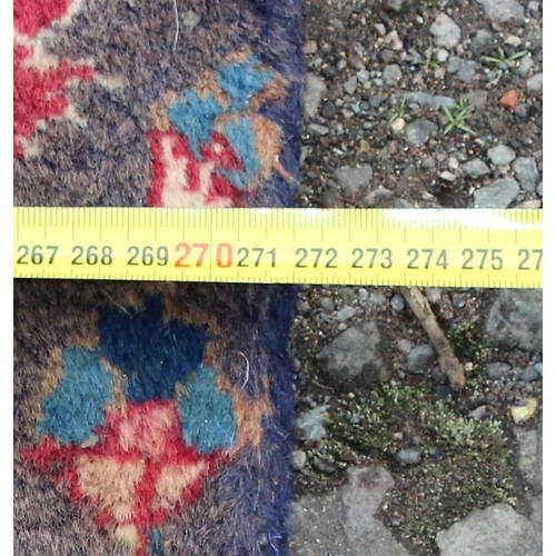 208 - A large decorative Persian rug of red ground with Herati border, approx 362cm x 271cm, label verso