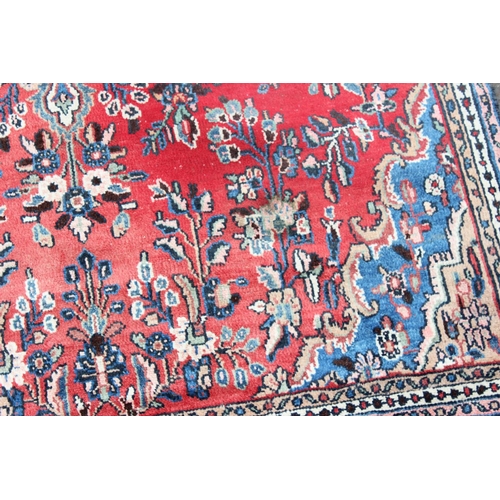 209 - A large decorative Iranian rug of red ground with geometric border, approx 313cm x 200cm, label vers... 