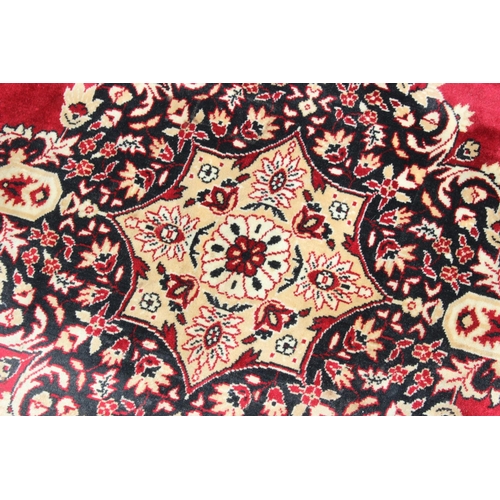 210 - A decorative red ground rug with central medallion, approx 190cm x 137cm