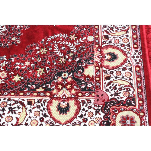 211 - A decorative Turkish red ground rug with central medallion
