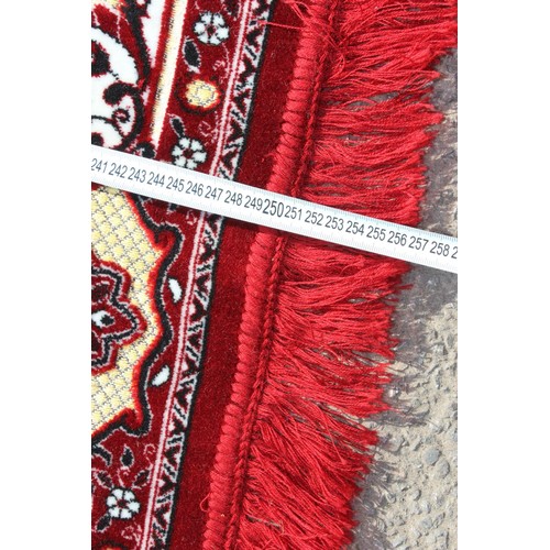 211 - A decorative Turkish red ground rug with central medallion
