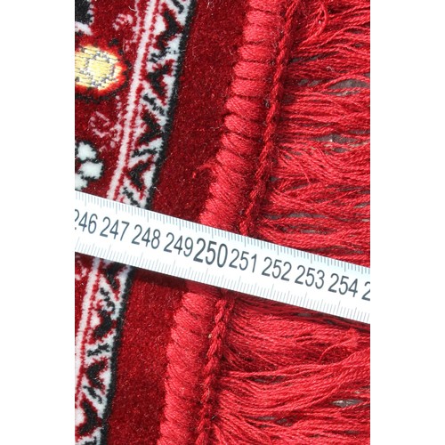211 - A decorative Turkish red ground rug with central medallion