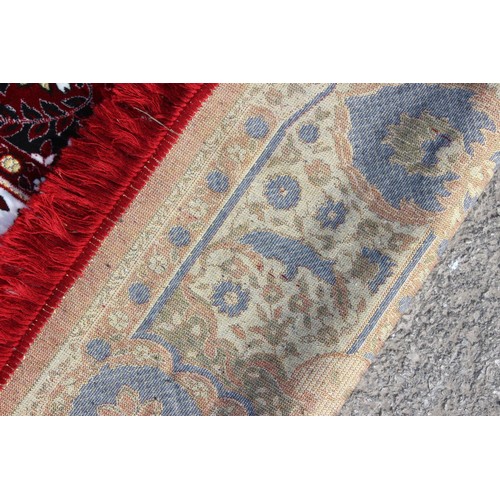 211 - A decorative Turkish red ground rug with central medallion