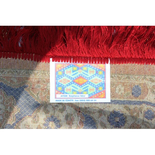 211 - A decorative Turkish red ground rug with central medallion