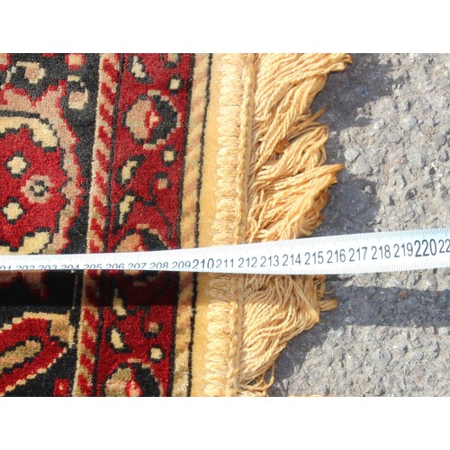 213 - A large decorative rug, likely Turkish, approx 213cm x 127cm