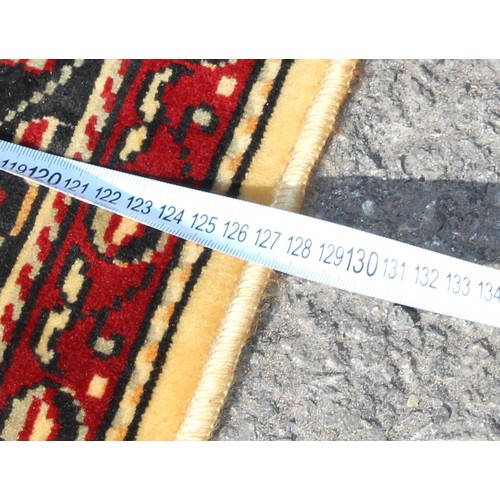 213 - A large decorative rug, likely Turkish, approx 213cm x 127cm
