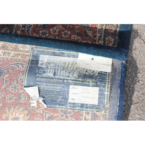 223 - A large blue ground rug with decorative Persian design