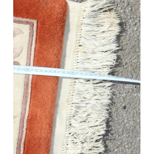225 - A thick pile Chinese superwash rug of burnt orange ground