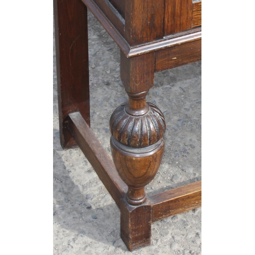 118 - A Jacobean style Oak glazed bookcase with leaded glass panels