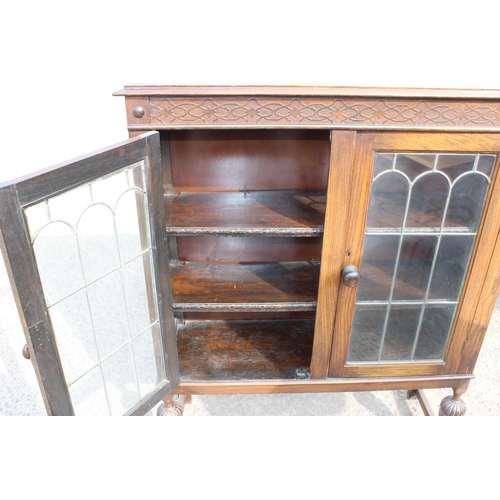 118 - A Jacobean style Oak glazed bookcase with leaded glass panels