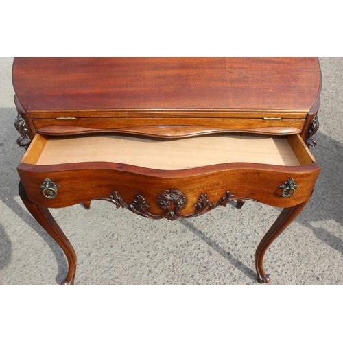 119 - An antique style Mahogany ladies writing desk with drawer, drop down front and carved details