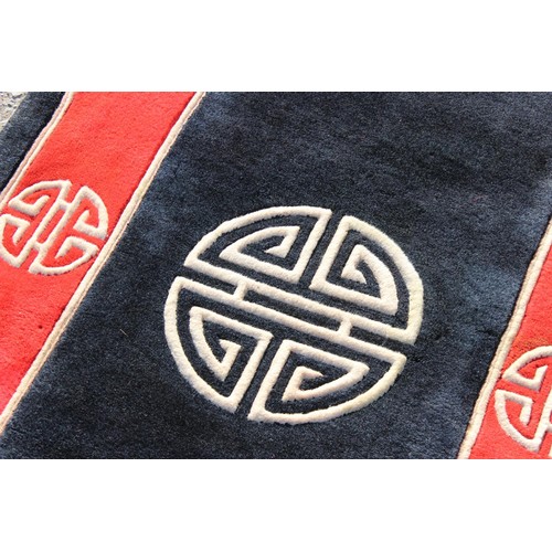 225A - An unusual black and red ground rug Chinese thick pile rug