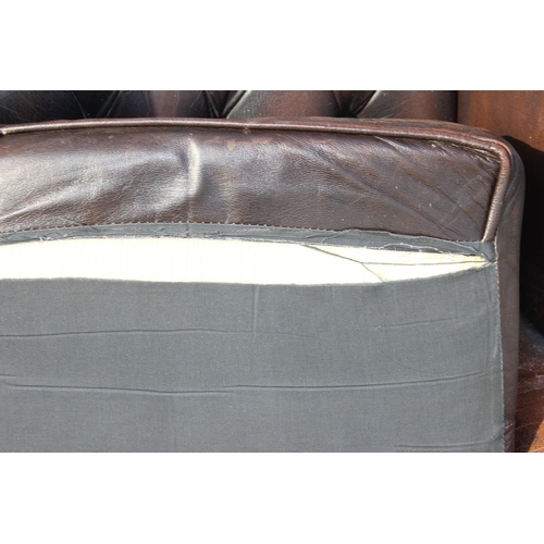 153 - A Georgian style leather brown leather Chesterfield wing back armchair