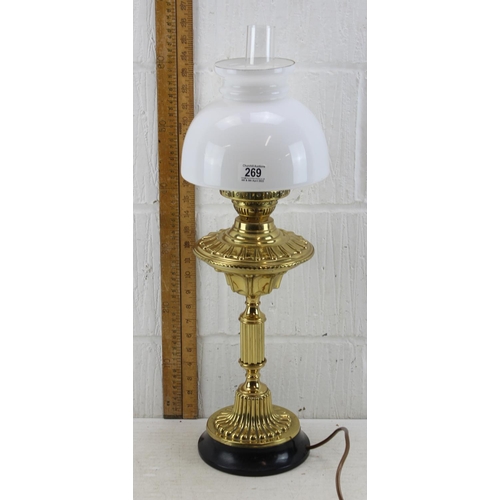 269 - A highly polished antique oil lamp with later electric conversion